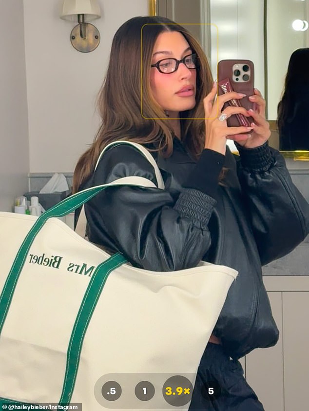 While posing inside of a spacious bathroom, she placed a tote bag over her shoulder that had 'Mrs. Bieber' printed in green lettering on the side