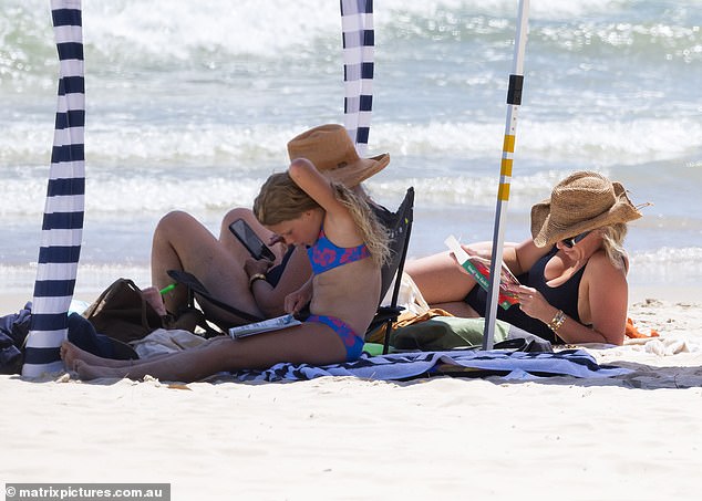 While relaxing on the beach, Phoebe was seen reading Maggie Alderson's novel, Would You Rather, which is a 'heartwarming family drama novel'