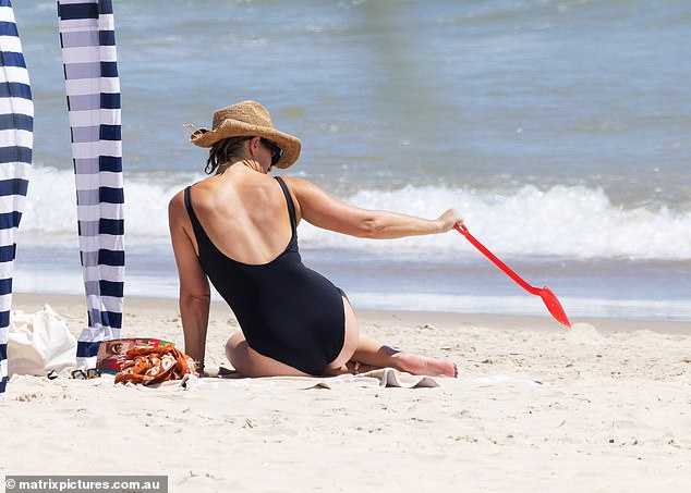 Phoebe was seen making some sandcastles as she enjoyed the quality time with her two kids