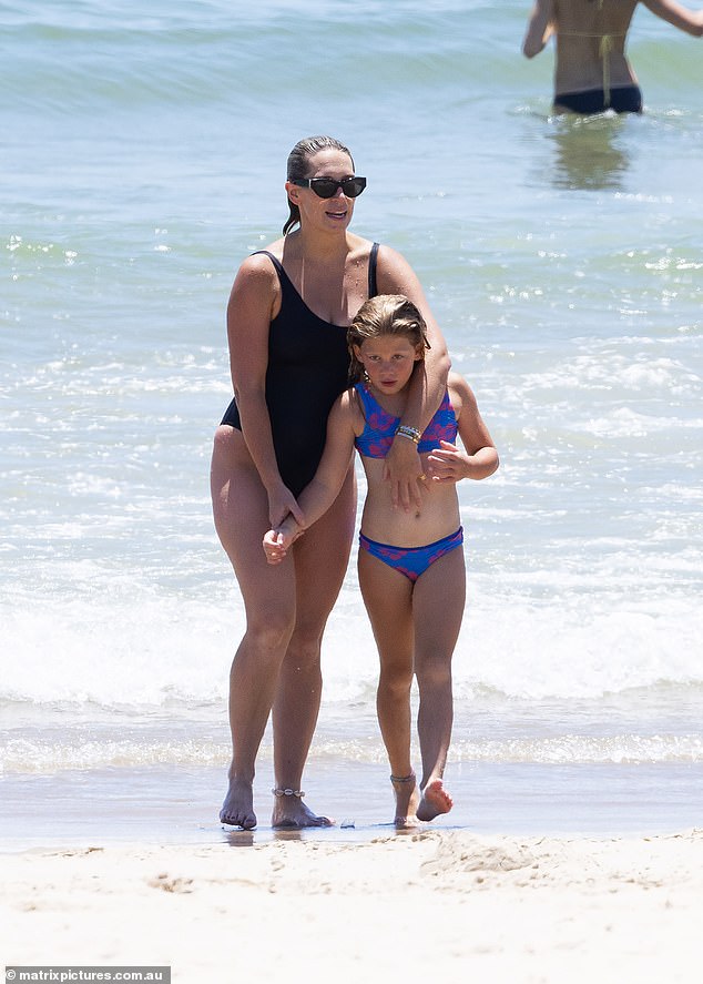 Phoebe was every inch the doting mother as she cuddled her daughter Poppy after they had a swim together