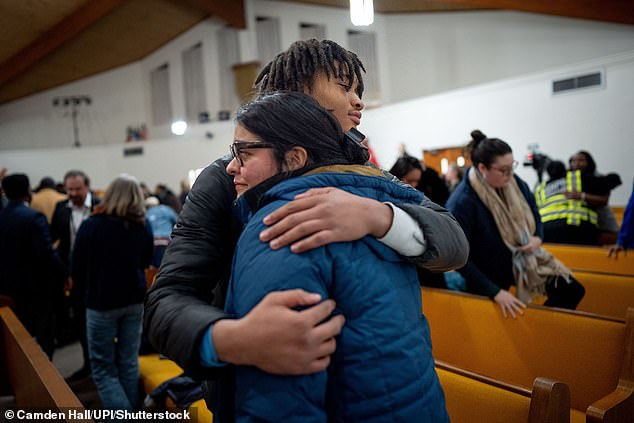 Jaden Ames, 17, a student at Antioch High School, embraces Jackie Gomez during a vigil at Hamilton United Methodist Church in Tennessee