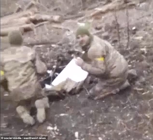 Ukrainian soldiers are seen cowering moments before they are shot dead