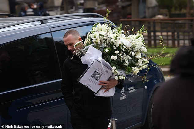 A bouquet of flowers is brought into the Crematorium ahead of a service for the Catwoman