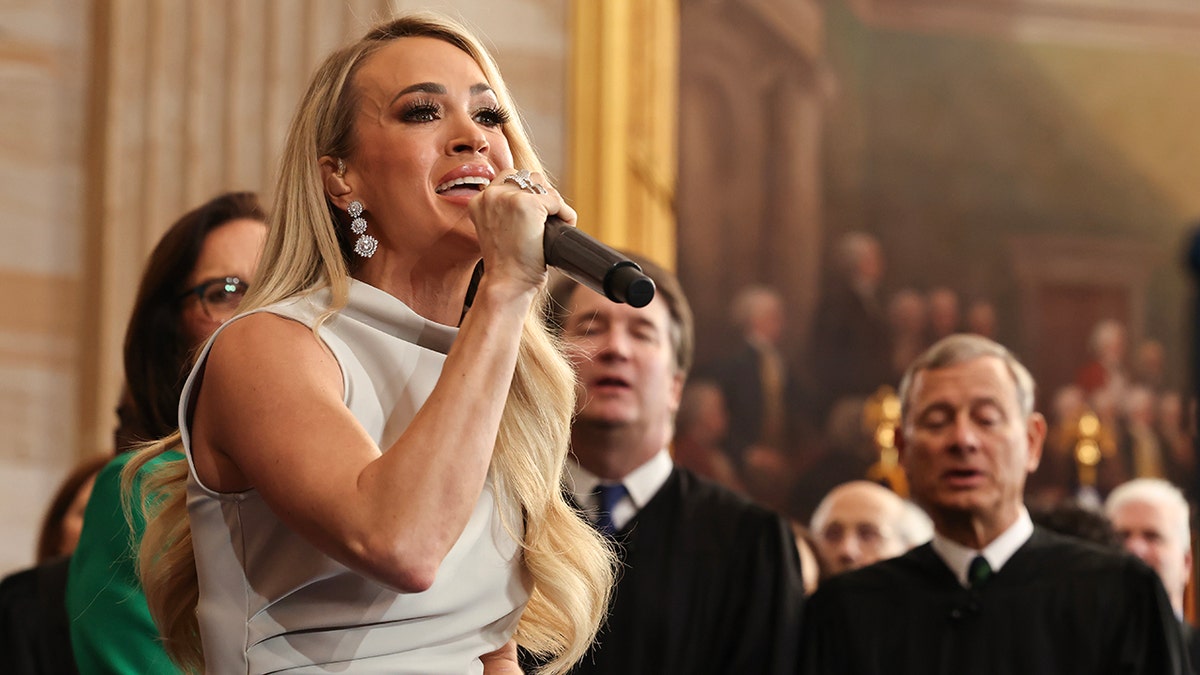 Carrie Underwood looks up as she sings