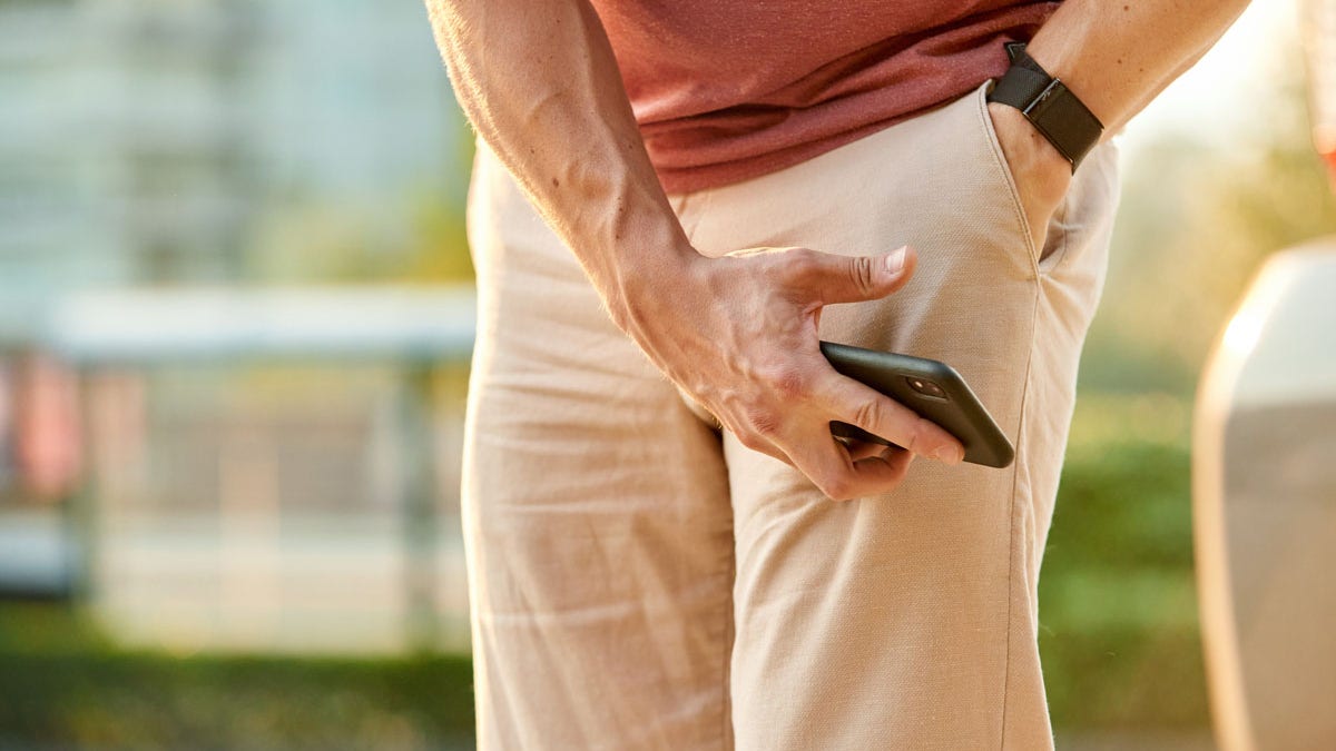 Man digging through pocket