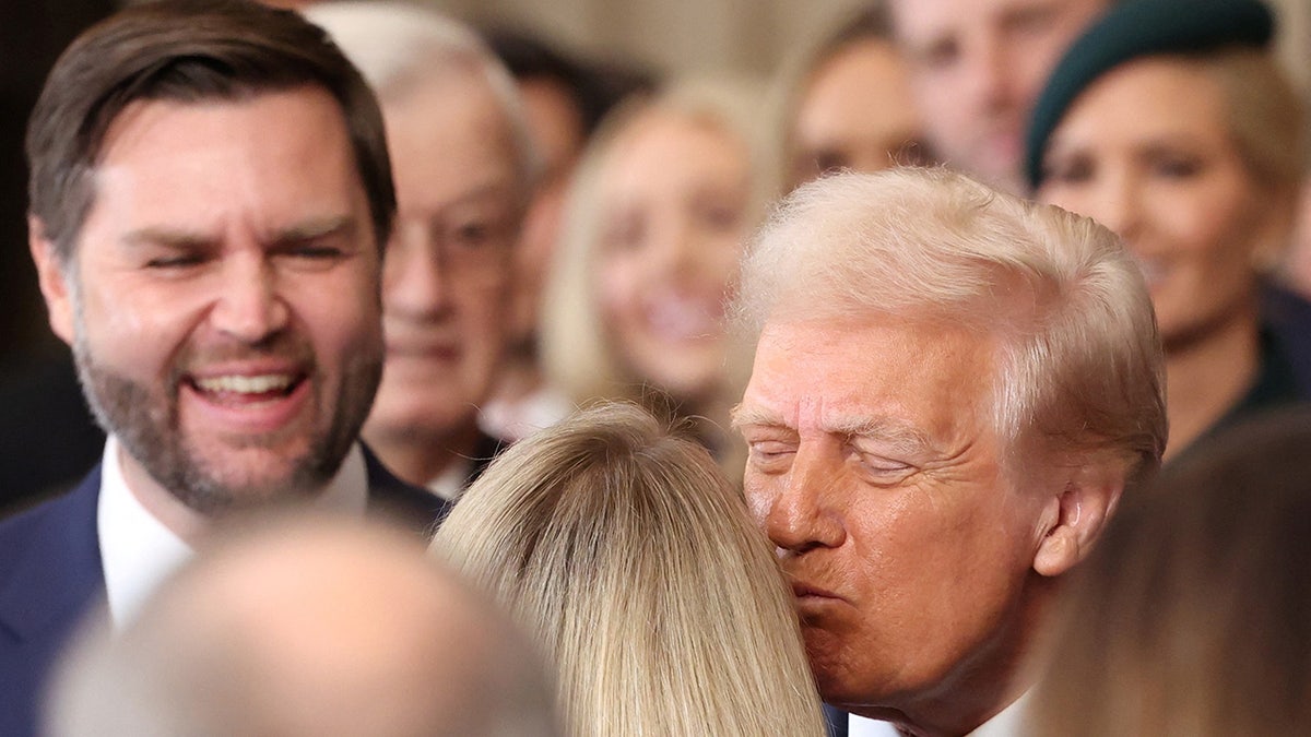 U.S. President Donald Trump kisses Carrie Underwood after she performed at his inauguration