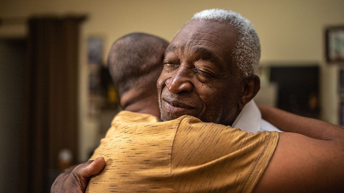 Bonding moment of father and son embracing and giving emotional support