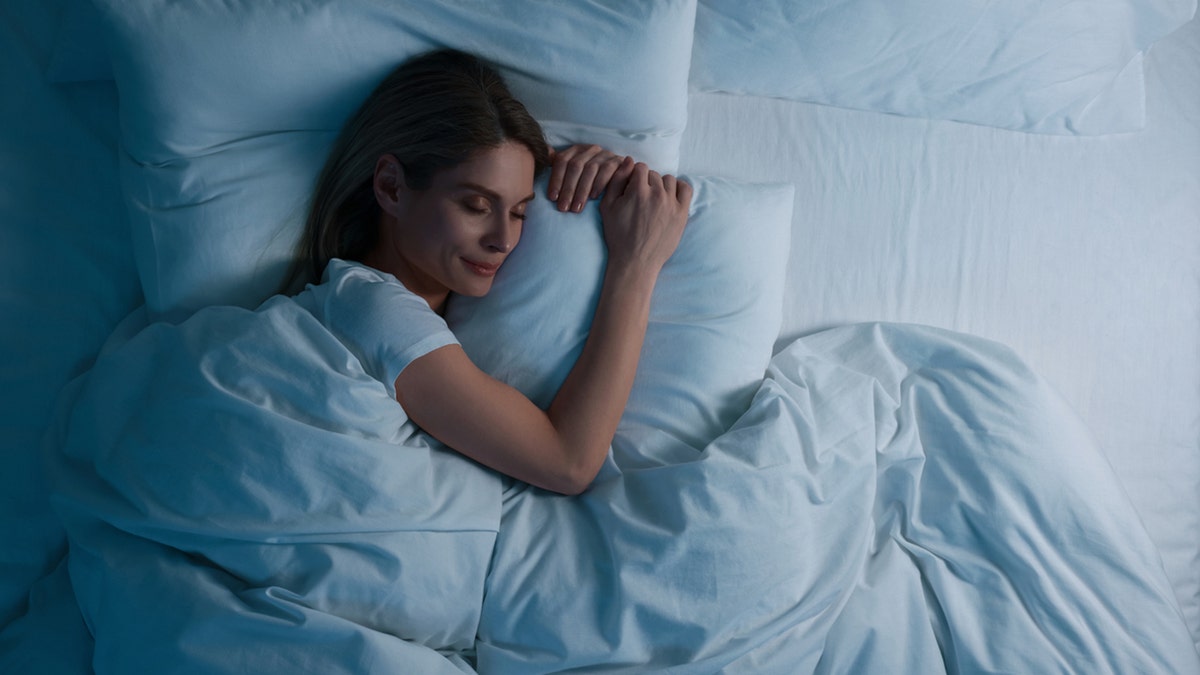 Woman sleeping in bed at night