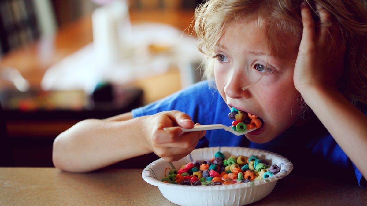 Kid eating sugary cereal