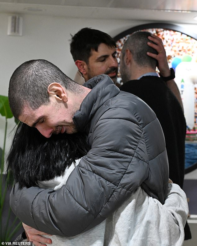 Released hostage Or Levy, who was seized during the deadly October 7, 2023 attack by Hamas, embraces a loved one as he is reunited with his family at Sheba Medical Center in Ramat Gan, Israel, in a handout photo obtained by Reuters on February 8, 2025