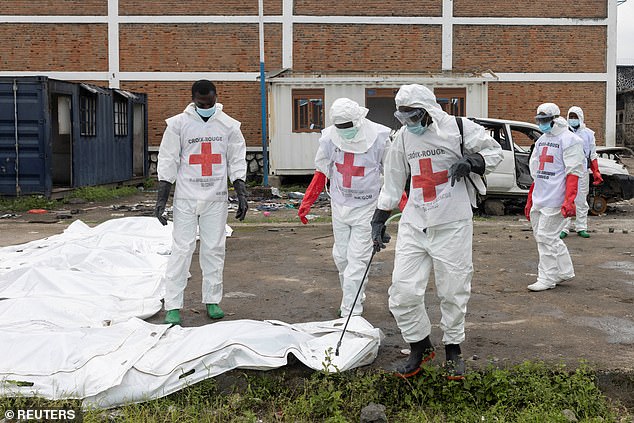 Red Cross volunteers remove the bodies of victims who died in a jailbreak and fire at Munzenze central prison, where some prisoners escaped during the capture of the city by M23 rebels, in Goma, North Kivu province, Democratic Republic of Congo, February 10, 2025