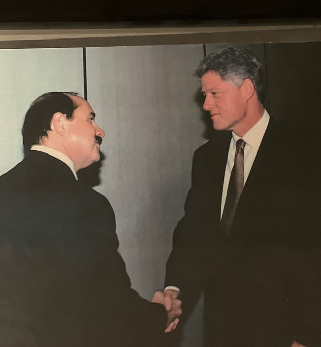 For 40 years, the imposter was known by his friends and associates as 'Nicholas Rockefeller', an eccentric scion of the billionaire family with a Yale degree and partnerships at major US law firms. He is pictured meeting then-President Bill Clinton